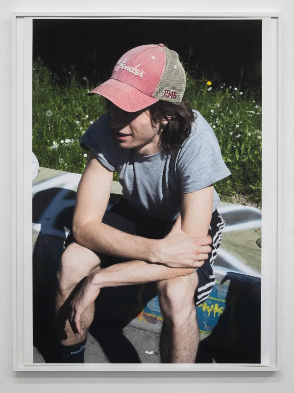Hannes sitting on concrete, 2025