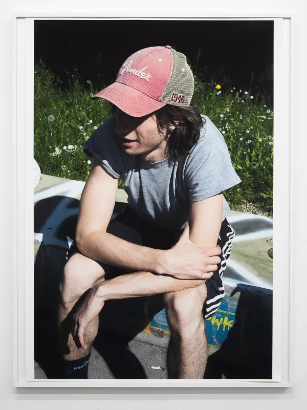 Hannes sitting on concrete, 2025